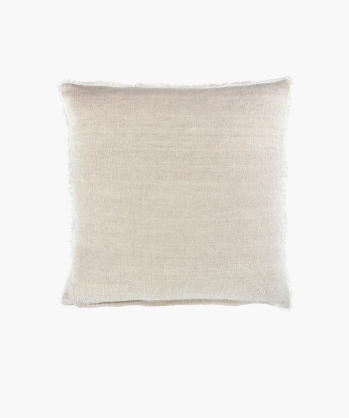 A natural linen square pillow with a smooth texture and slightly frayed edges. The neutral tone conveys simplicity and elegance, suitable for minimalistic decor. | Wildwood Home Co.