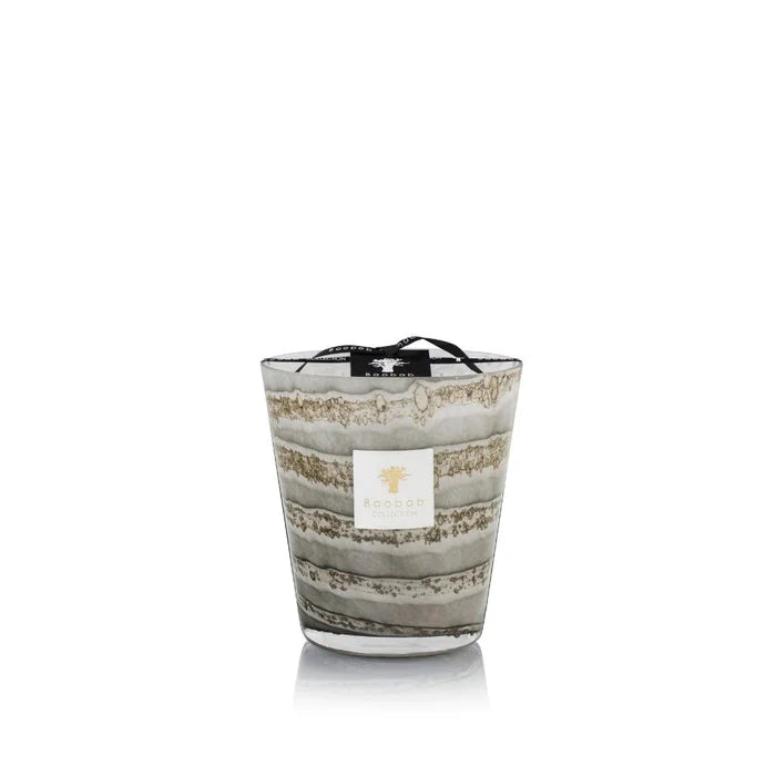 A set of hand-blown gray glass candles with various sizes, each holding a candle with a beige label.