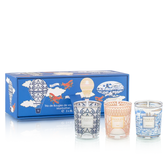 Set of three candles in decorative glass containers with a blue box featuring illustrations on a white background.