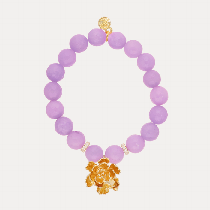 a purple beaded bracelet with a gold flower pendant