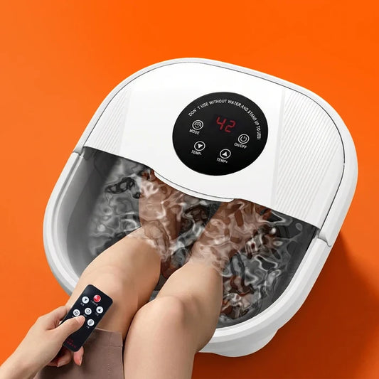 Foot spa with a white exterior, digital control panel, and water-filled basin, featuring feet submerged in warm water.