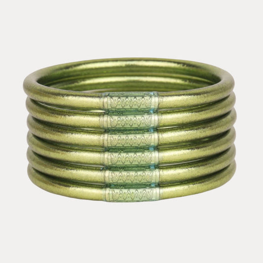 a stack of green bracelets