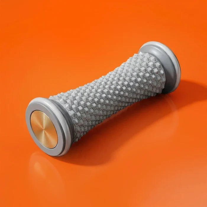 Gray massage roller with a textured surface and metallic end caps, placed on an orange background.