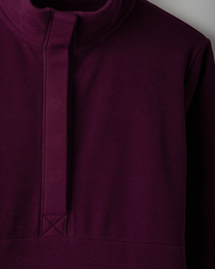 Close-up of the burgundy Morgan women's 1/4 neck longline fleece by Saltrock, featuring a high funnel neck and a quarter-length front zipper.