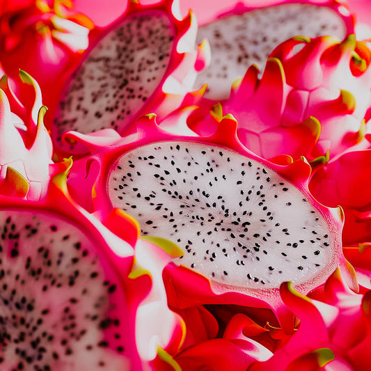 A close-up image of a neon pink dragonfruit with a slice removed to reveal the white seed-speckled interior.