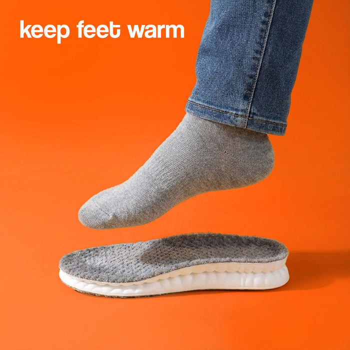 A foot wearing a gray sock hovering over a gray plush massage insole.