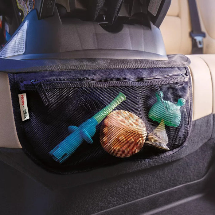 The Nuby Safe in the Seat Car Seat Protector in beige features a black mesh organizer on the back, which holds children's toys such as a blue object, a turtle-shaped toy, and an orange ball.