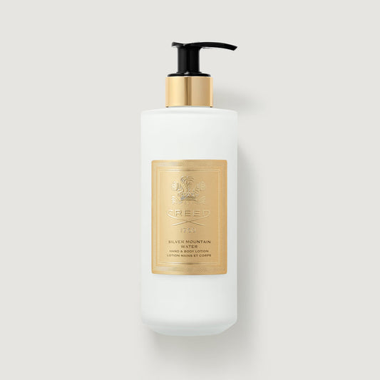 White pump bottle with gold label - Creed Silver Mountain Water Hand & Body Lotion 300ml - Front View | Creed Boutique