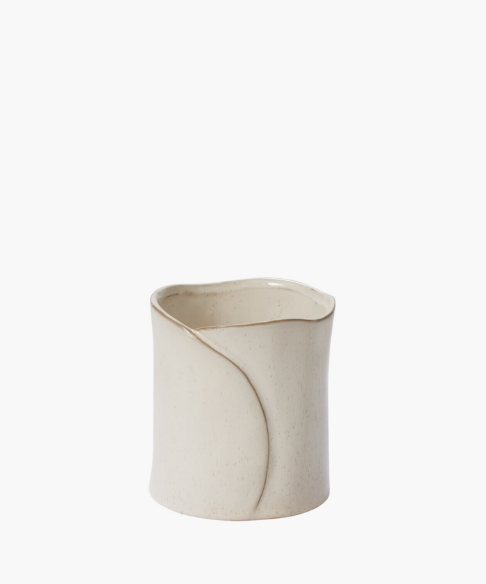 Elegant cream-colored ceramic vase with a smooth, curvy design and subtle speckled texture, evoking a minimalist and serene aesthetic. | Wildwood Home Co.